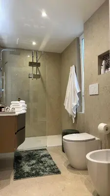 a bathroom with a shower and a toilet and a sink at CEMMA luxury apartment in Rome
