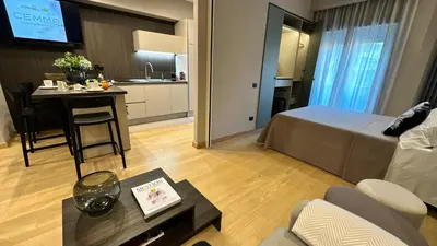 a room with a bed and a table and a kitchen at CEMMA luxury apartment in Rome