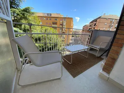 a balcony with two chairs and a table at CEMMA luxury apartment in Rome