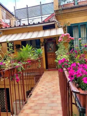 a walkway leading to a house with flowers at Alloggio vicino Termini La Casetta in Rome