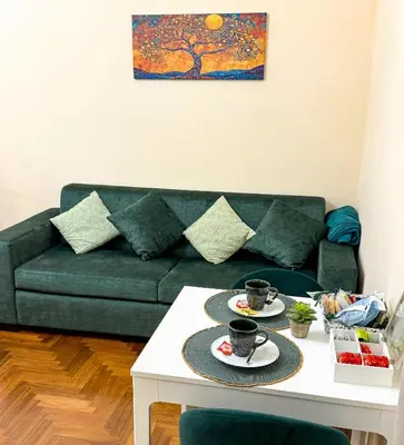 a living room with a couch and a table with two cups at Alloggio vicino Termini La Casetta in Rome