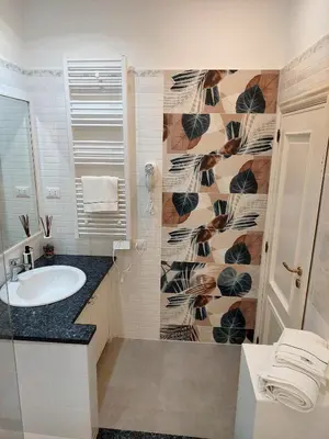 a bathroom with a sink and a shower with a wall at Alloggio vicino Termini La Casetta in Rome