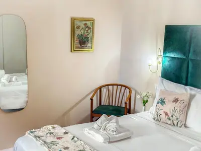 a room with a bed with a mirror and a chair at Alloggio vicino Termini La Casetta in Rome