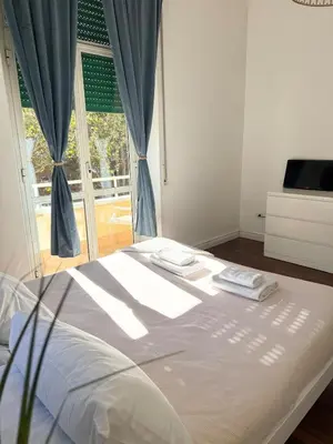 a bedroom with a large bed with a window at Volupta' s house Trastevere Station in Rome