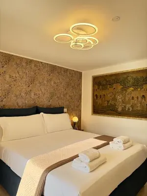 a bedroom with a large bed with towels on it at Rooftop View St Peter by Dama in Rome