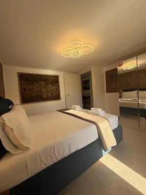 a bedroom with a large bed and a bathroom at Rooftop View St Peter by Dama in Rome