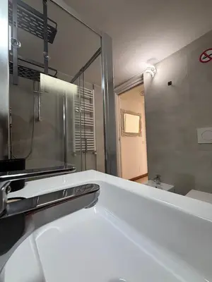 a bathroom with a sink and a mirror at Rooftop View St Peter by Dama in Rome