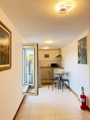 a kitchen and dining room with a table and chairs at Rooftop View St Peter by Dama in Rome