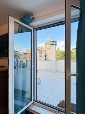 a sliding glass door with a view of a patio at Rooftop View St Peter by Dama in Rome