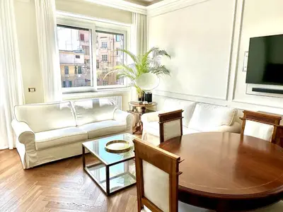a living room with a table and a couch at Dandy Elegance Loft in Rome