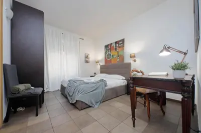 a bedroom with a bed and a desk and a piano at 4BNB - Otello in Rome