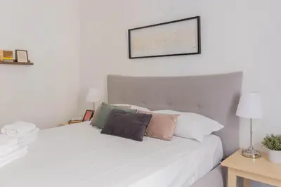 a bedroom with a white bed with pillows on it at Falstaff in Rome