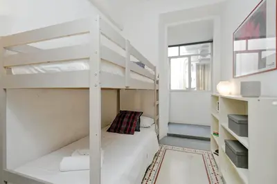 a small room with a bunk bed and a ladder at Falstaff in Rome