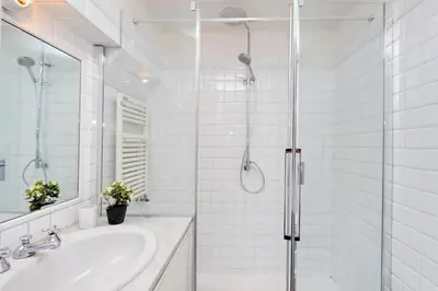a white bathroom with a shower and a sink at Falstaff in Rome