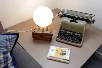 an old typewriter on a table with a lamp and a book at Falstaff in Rome