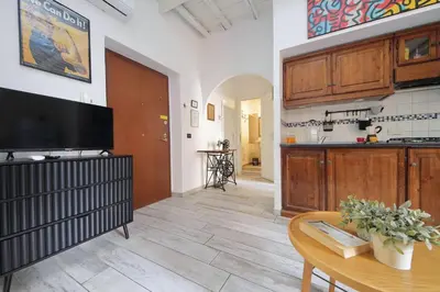 a living room with a television and a table at Fidelio Holiday Home in Rome