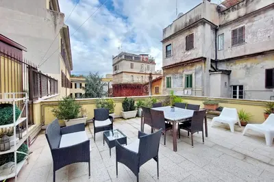 a patio with a table and chairs on a balcony at Fidelio Holiday Home in Rome