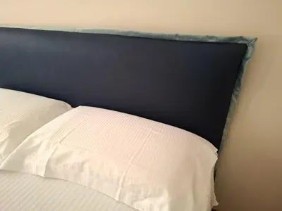 a bed with a black headboard and a white pillow at Sophìa, City Retreat near Vatican in Rome