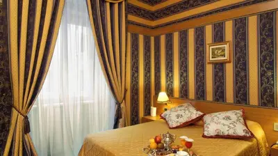 a bedroom with a bed with a table with fruit on it at LH Hotel Andreotti in Rome