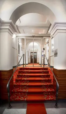a red carpeted staircase in a building at LH Hotel Andreotti in Rome
