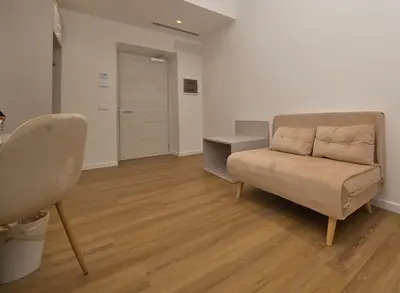 a living room with a couch and a table at LH Hotel Andreotti in Rome