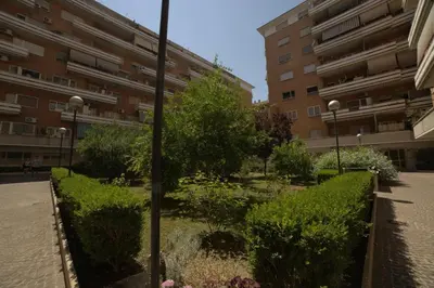 a garden in front of an apartment building at Suites Conca D'Oro, Roma in Rome