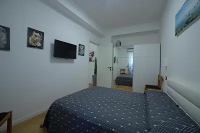 a bedroom with a bed and a television in it at Suites Conca D'Oro, Roma in Rome