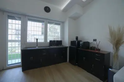 a large room with a kitchen with windows at Suites Conca D'Oro, Roma in Rome