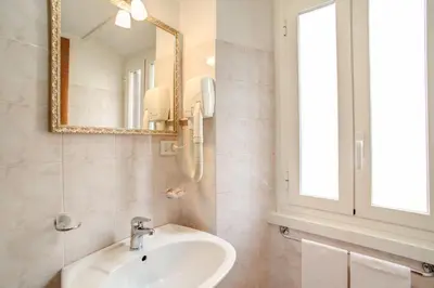 a bathroom with a sink and a mirror at Monti Guest House - Affittacamere in Rome