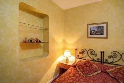 a bedroom with a bed and a lamp on a table at Monti Guest House - Affittacamere in Rome
