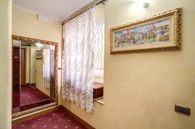 a room with a mirror and a picture on the wall at Monti Guest House - Affittacamere in Rome