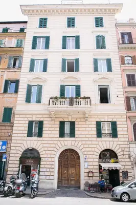 a large white building with a balcony on top of it at Nerva Accommodation Cavour in Rome