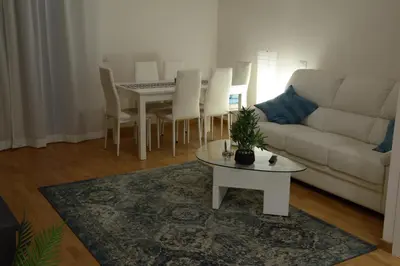 a living room with a white couch and a table at Casa Maloia in Rome