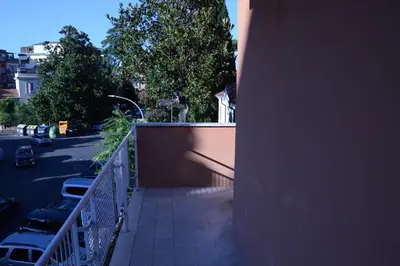 a balcony of a building with cars parked on a street at Casa Maloia in Rome