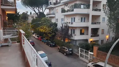 a city street with cars parked in front of a building at Casa Maloia in Rome