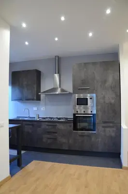 a kitchen with stainless steel appliances and a stove at Casa Maloia in Rome