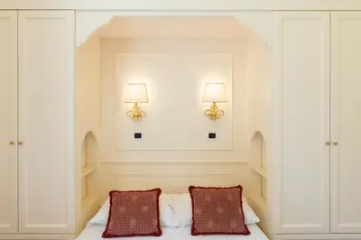 a bedroom with two pillows on a bed with two lights at Baccina Apartment by Rental in Rome in Rome