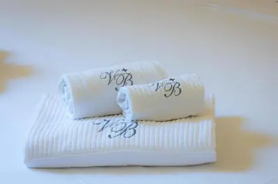a stack of towels sitting on top of a table at Baccina Apartment by Rental in Rome in Rome