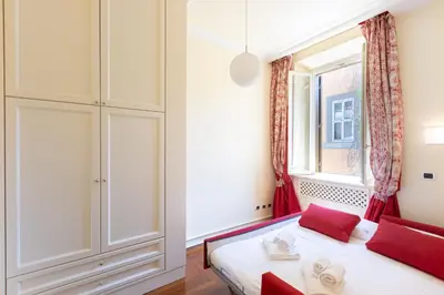 a bedroom with a bed and a window at Baccina Apartment by Rental in Rome in Rome