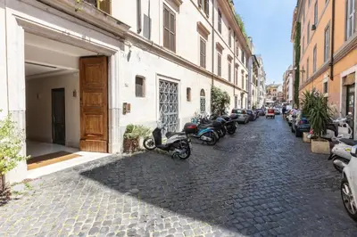 a cobblestone street with motorcycles parked next to buildings at Baccina Apartment by Rental in Rome in Rome