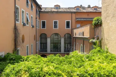 an old building with a bunch of green bushes at Baccina Apartment by Rental in Rome in Rome