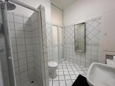 a white bathroom with a toilet and a sink at Tiziano House by Ghor in Rome