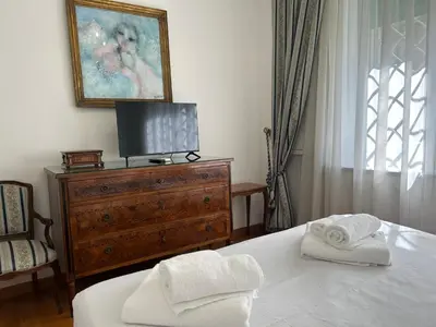 a bedroom with a bed and a tv on a dresser at Tiziano House by Ghor in Rome