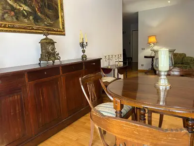 a dining room with a table and a painting on the wall at Tiziano House by Ghor in Rome