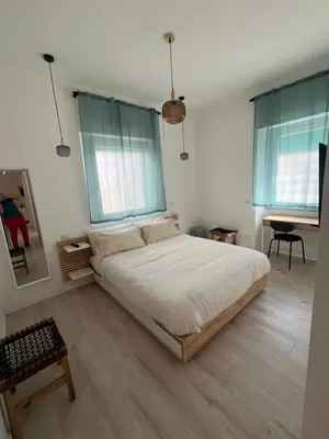 a bedroom with a large bed with two windows at CAFE Balduina in Rome
