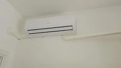 a white air conditioner on a wall in a room at CAFE Balduina in Rome