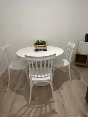 a white table and chairs with a plant on it at CAFE Balduina in Rome