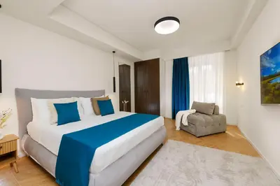 a bedroom with a large bed and a chair at Eden Luxury Apartment in Rome