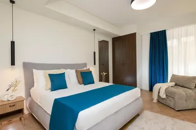 a bedroom with a large bed and a chair at Eden Luxury Apartment in Rome