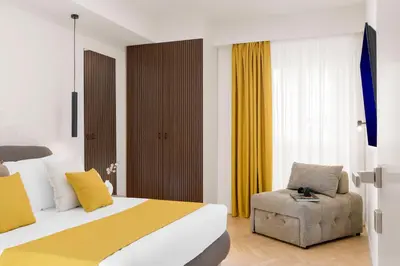 a hotel room with a bed and a chair at Eden Luxury Apartment in Rome